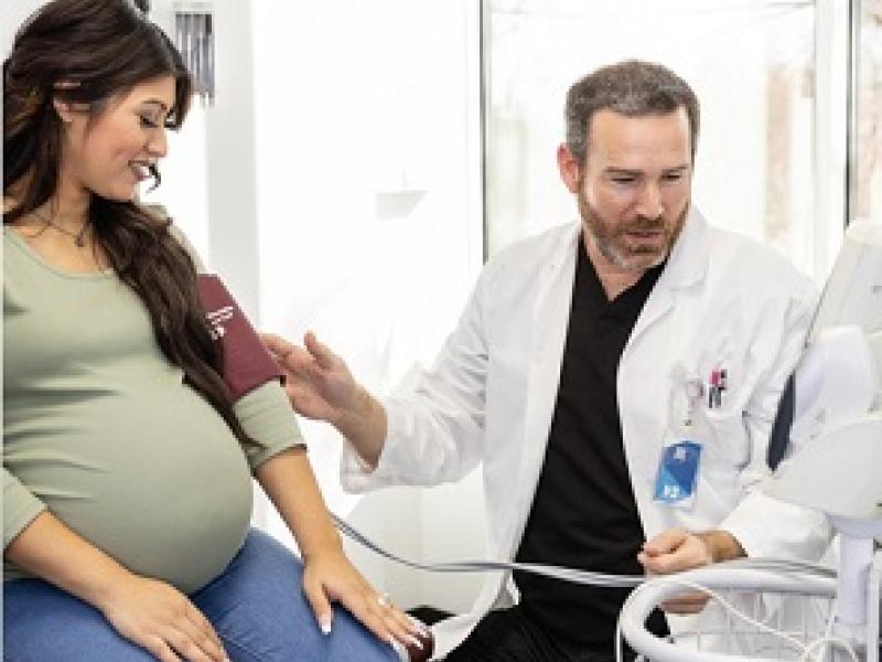 Pregnant woman getting checkup done from doctor