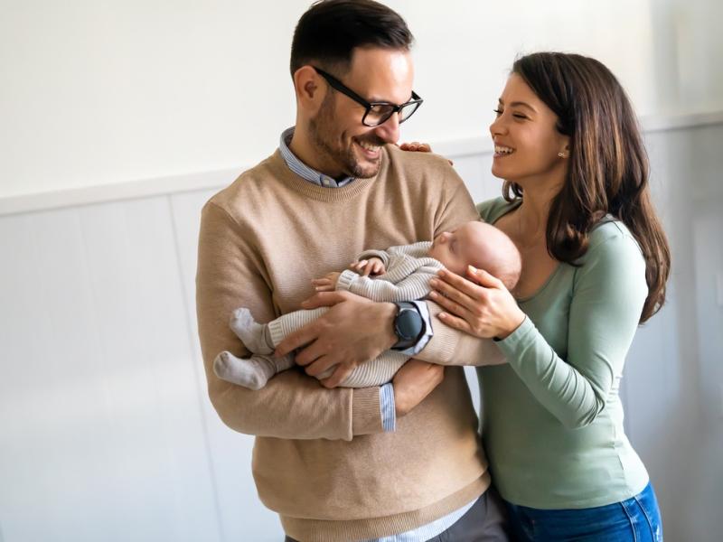 New parents holding baby