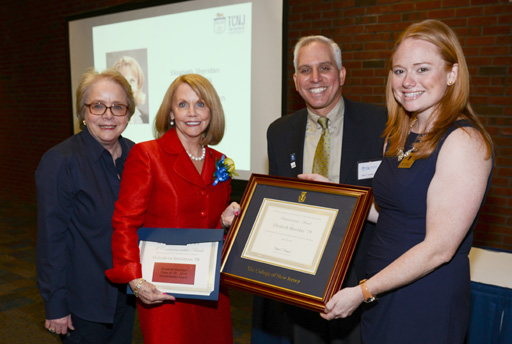 Elizabeth Sheridan in group picture holding award