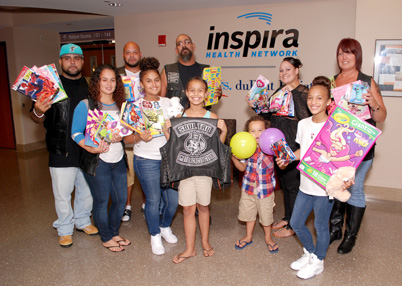 Members of Soul Tru stand with young patients at Inspira Medical Center Vineland.