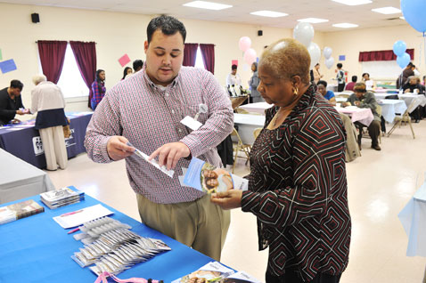 Matthew Brown speaks to woman at Body and Soul event.