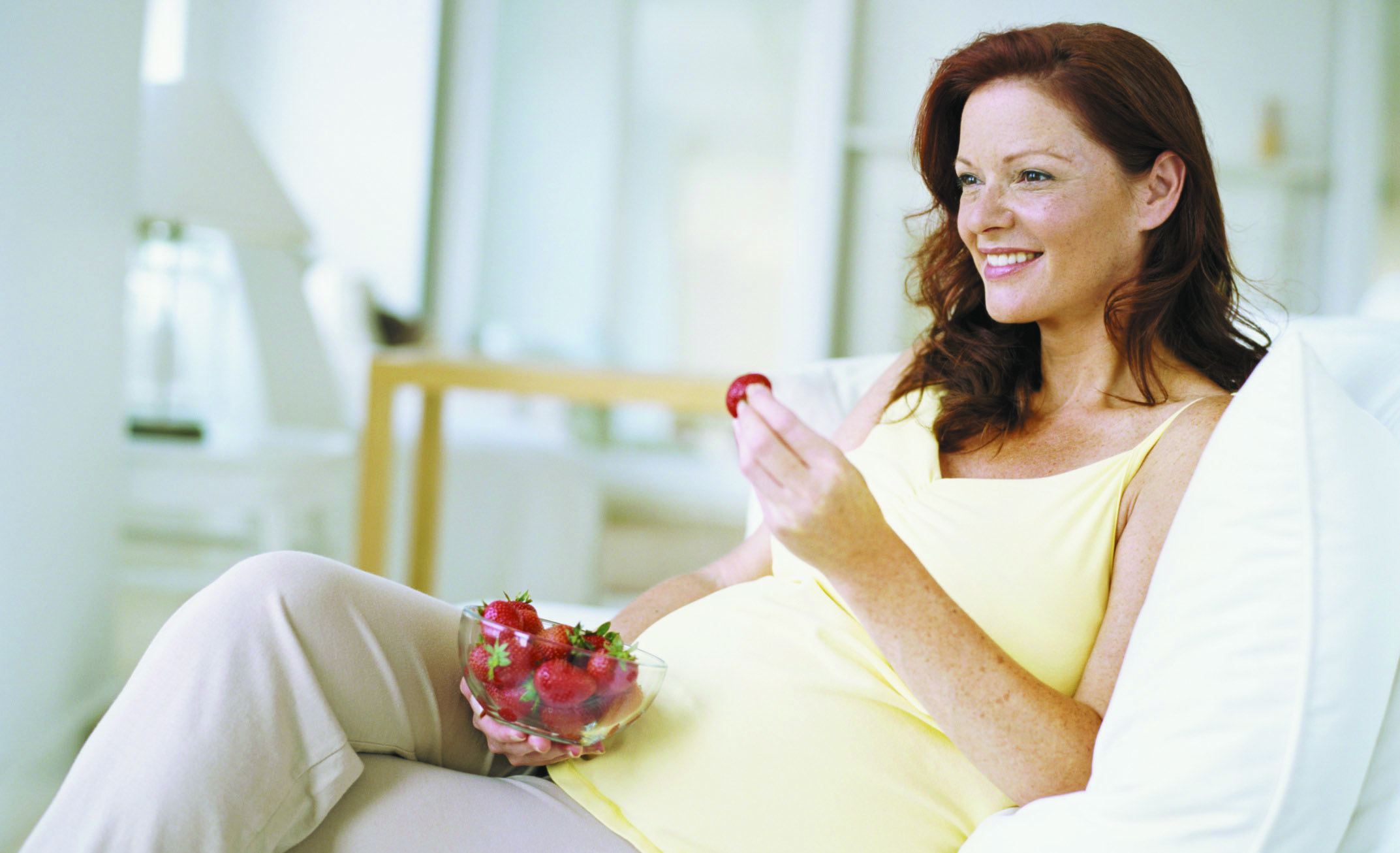 A Pregnant woman eating a healthy snack