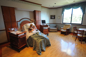 Woman holding a baby in a birthing suite. 