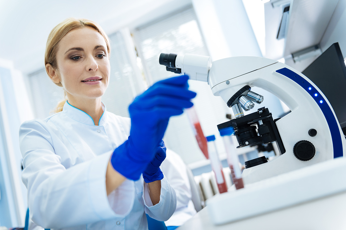 Medical Worker with vials and a microscope