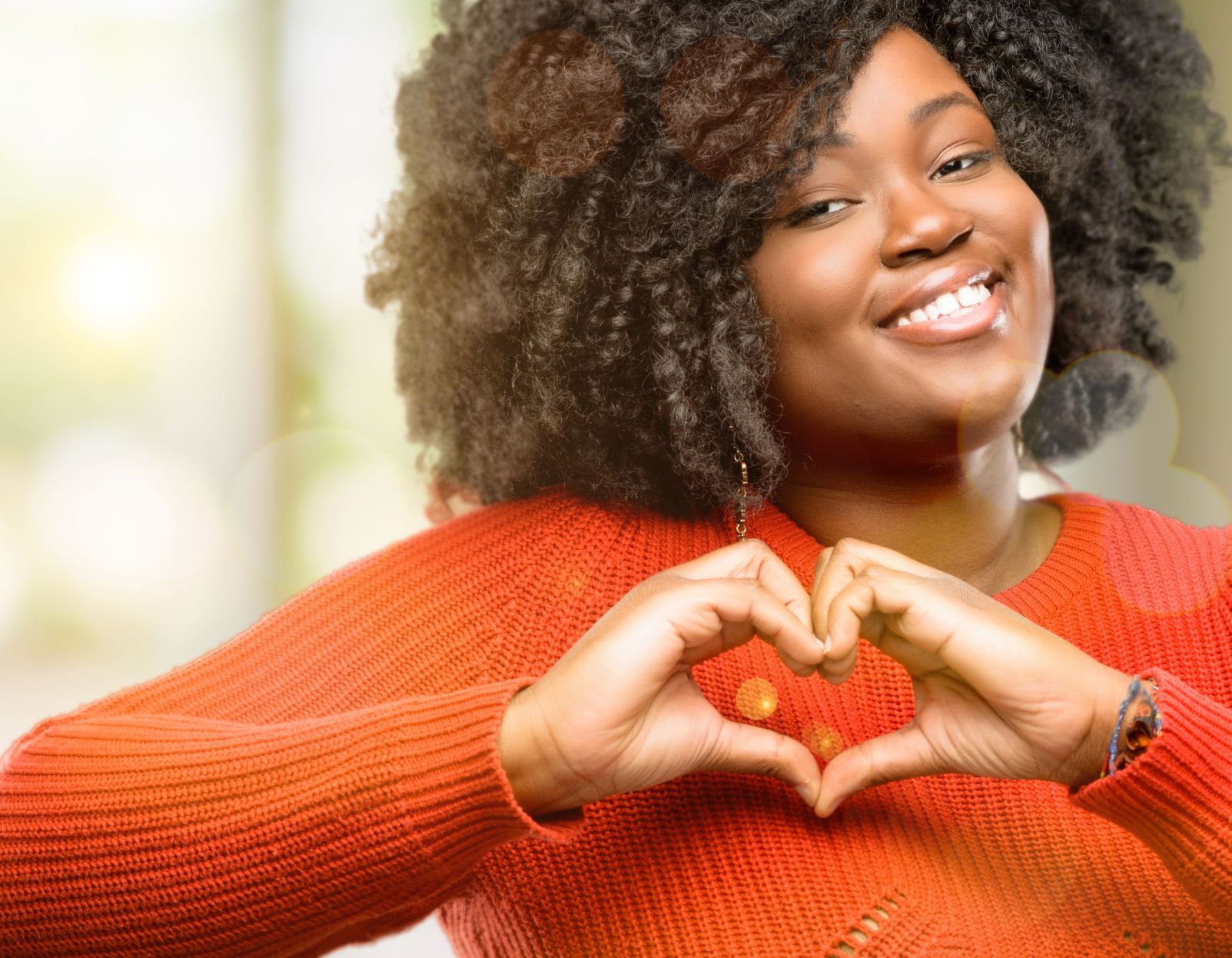 A woman making a heart sign with her hands