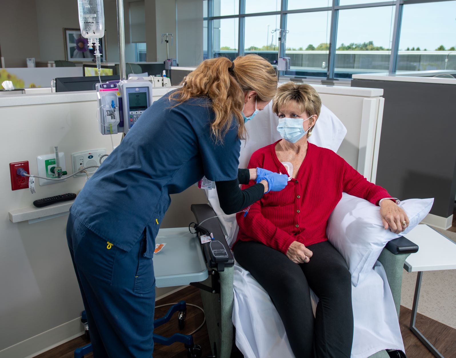 nurse checking on a cancer patient receiving treatment