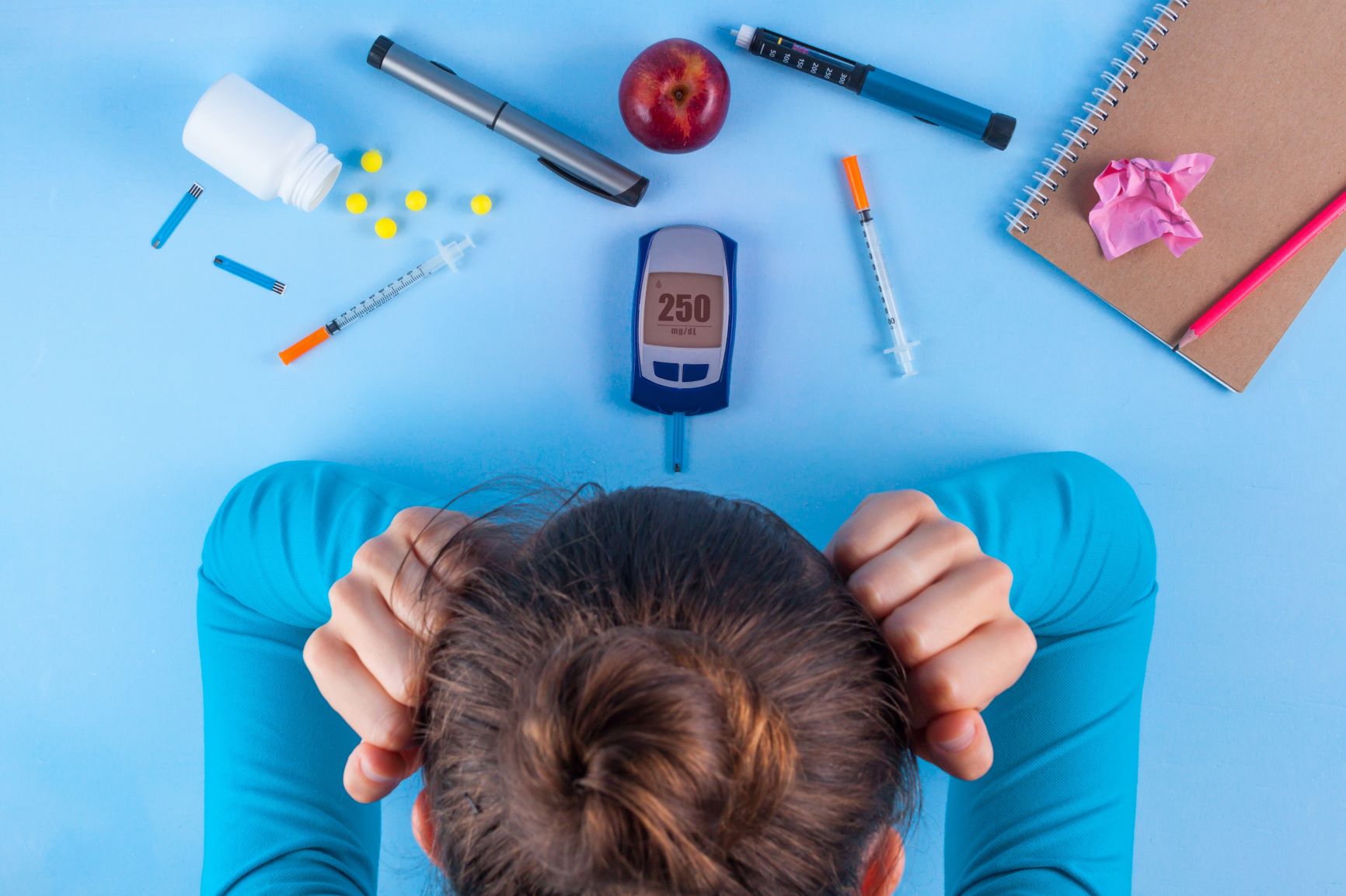 diabetic with tester, medicine, and a log