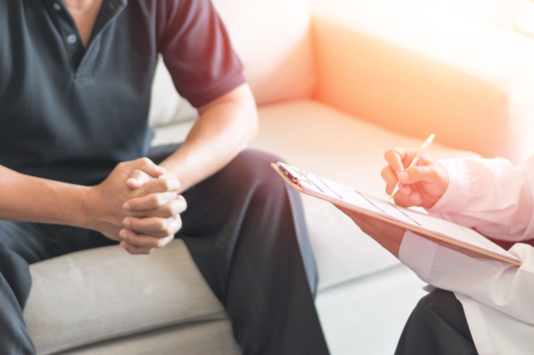 A mental health practitioner consulting a male