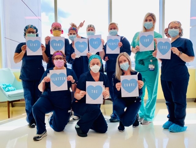 nurses holding blue heart signs