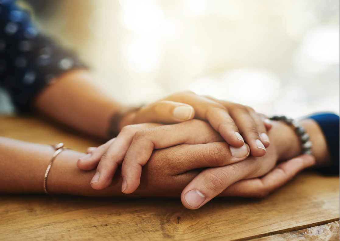 Two people holding hands