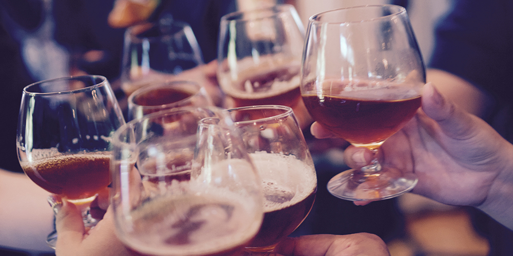 A group of people clinking their drinking glasses together
