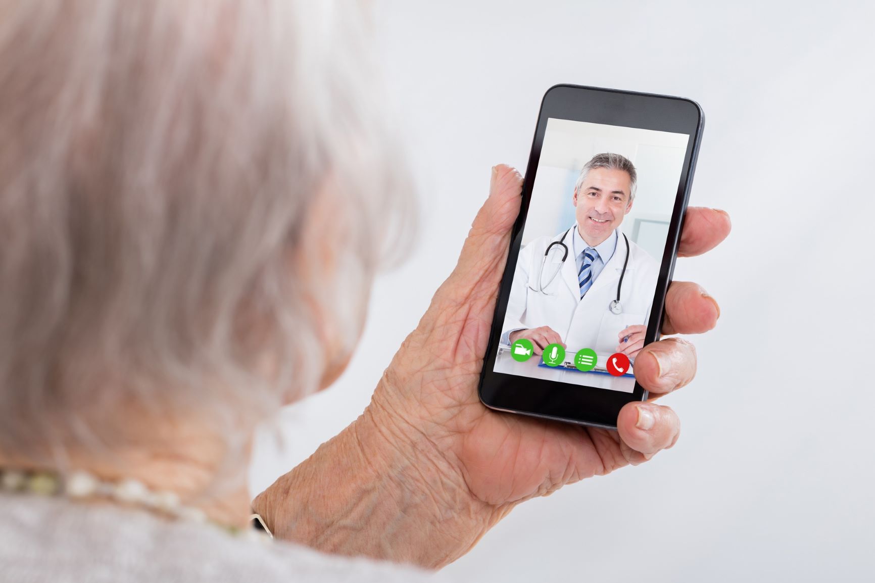 older woman facetiming with a male physician