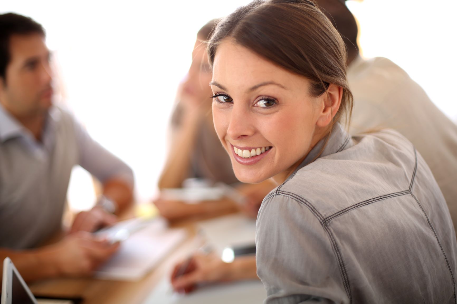 female smiling in a study group with two men and another woman