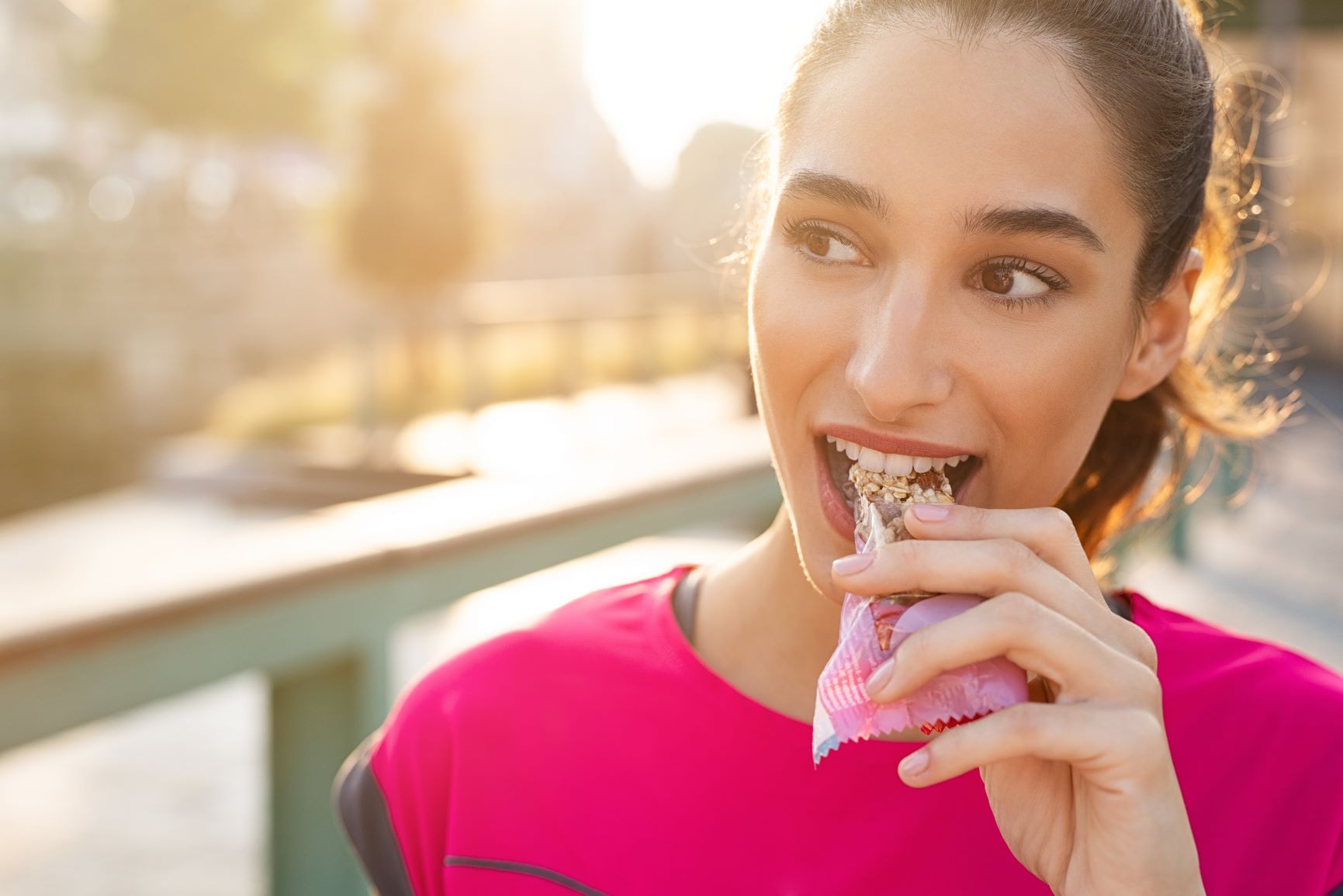 A person eating a granola bar