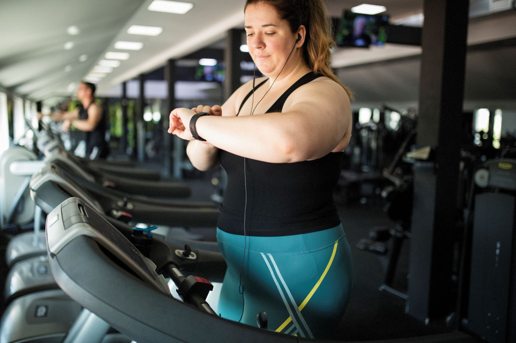 Woman on a treadmill checking her watch