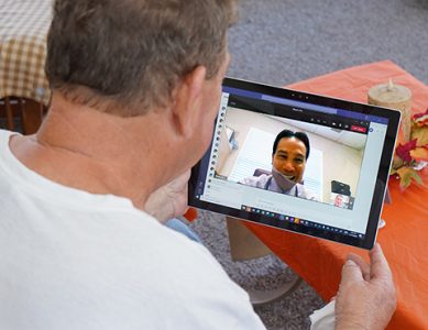 man viewing an ipad during a telehealth appointment with a physician