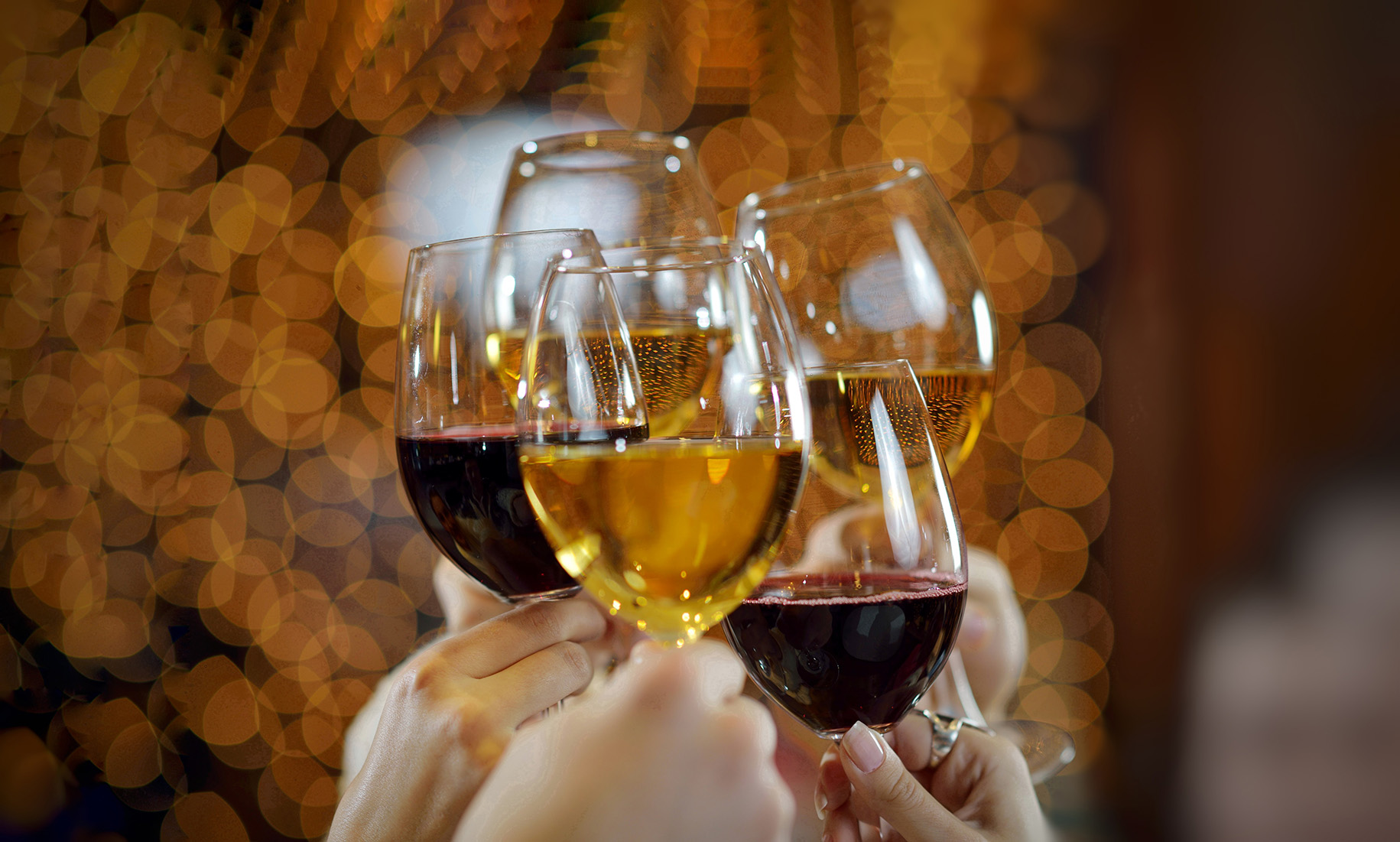 New year Red wine glass celebration 2019. hand with lots of alcoholic drink