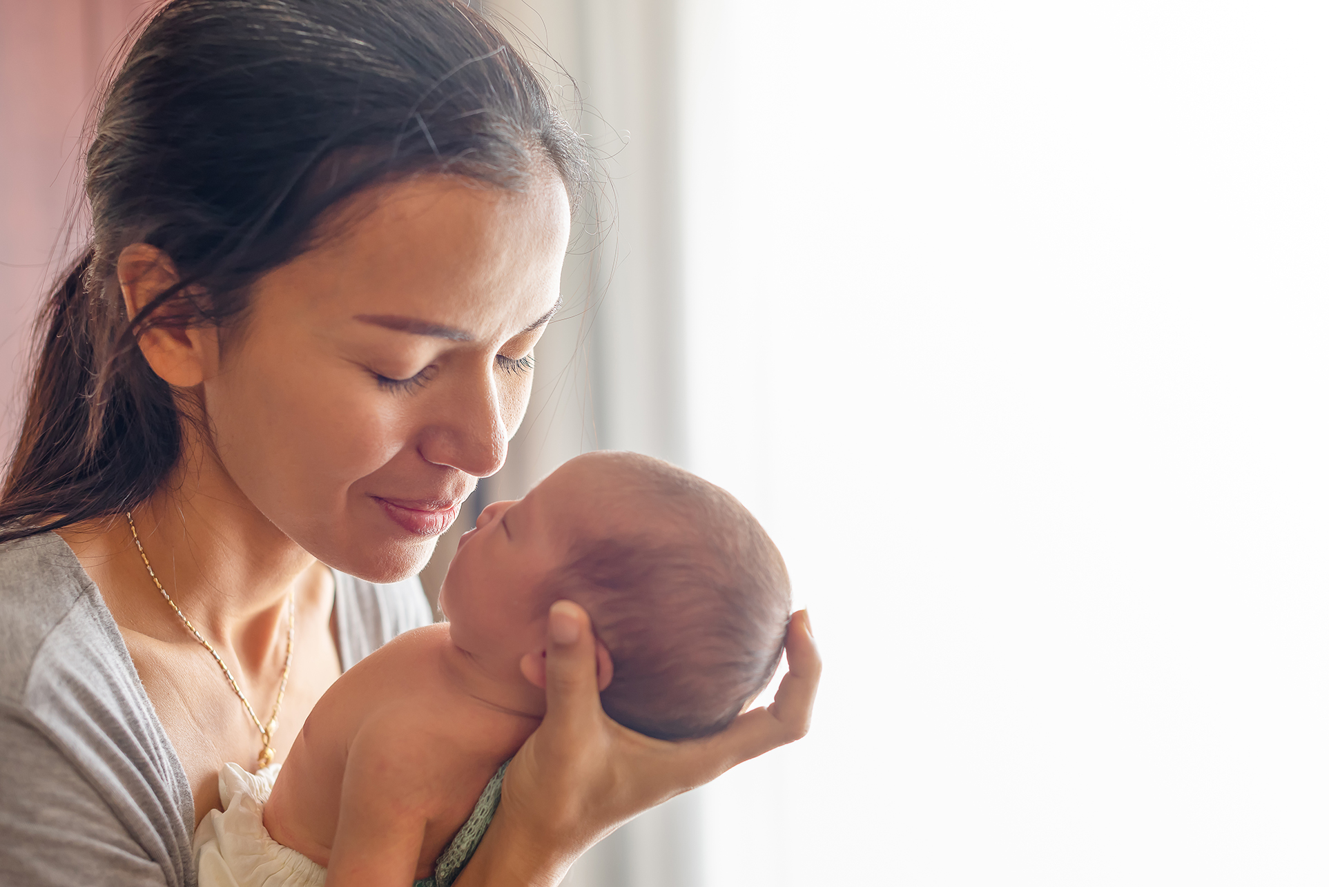 Mom kisses baby