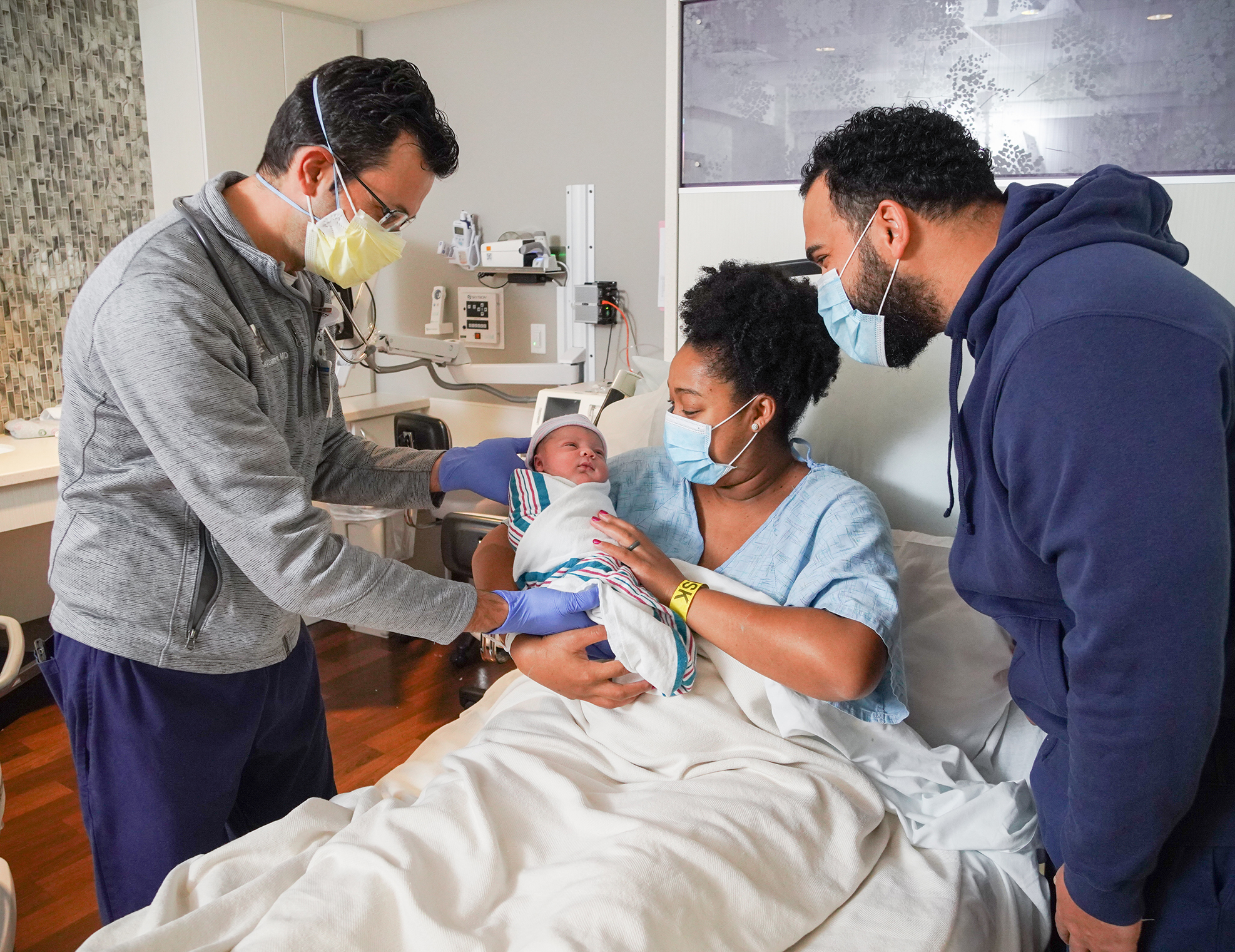 Mom and dad holding child