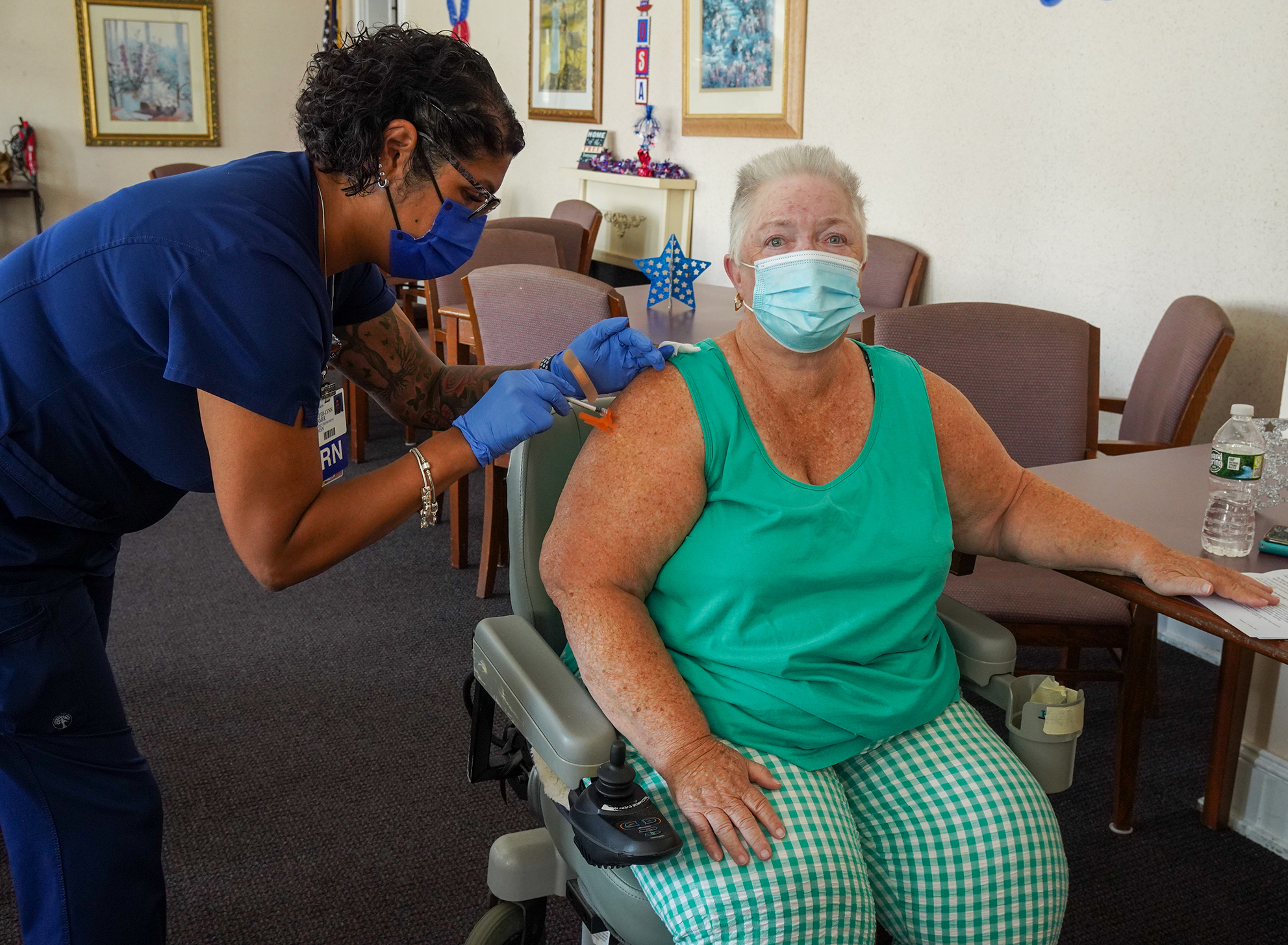 Joan Lentine receiving the 100,000 dose of the COVID Vaccine