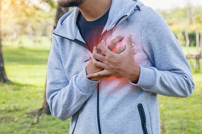 man clutching his heart