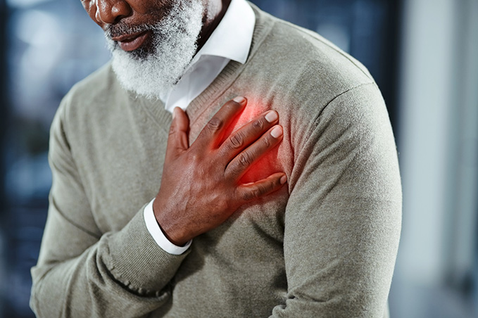 Shot of a senior man holding his chest in discomfort