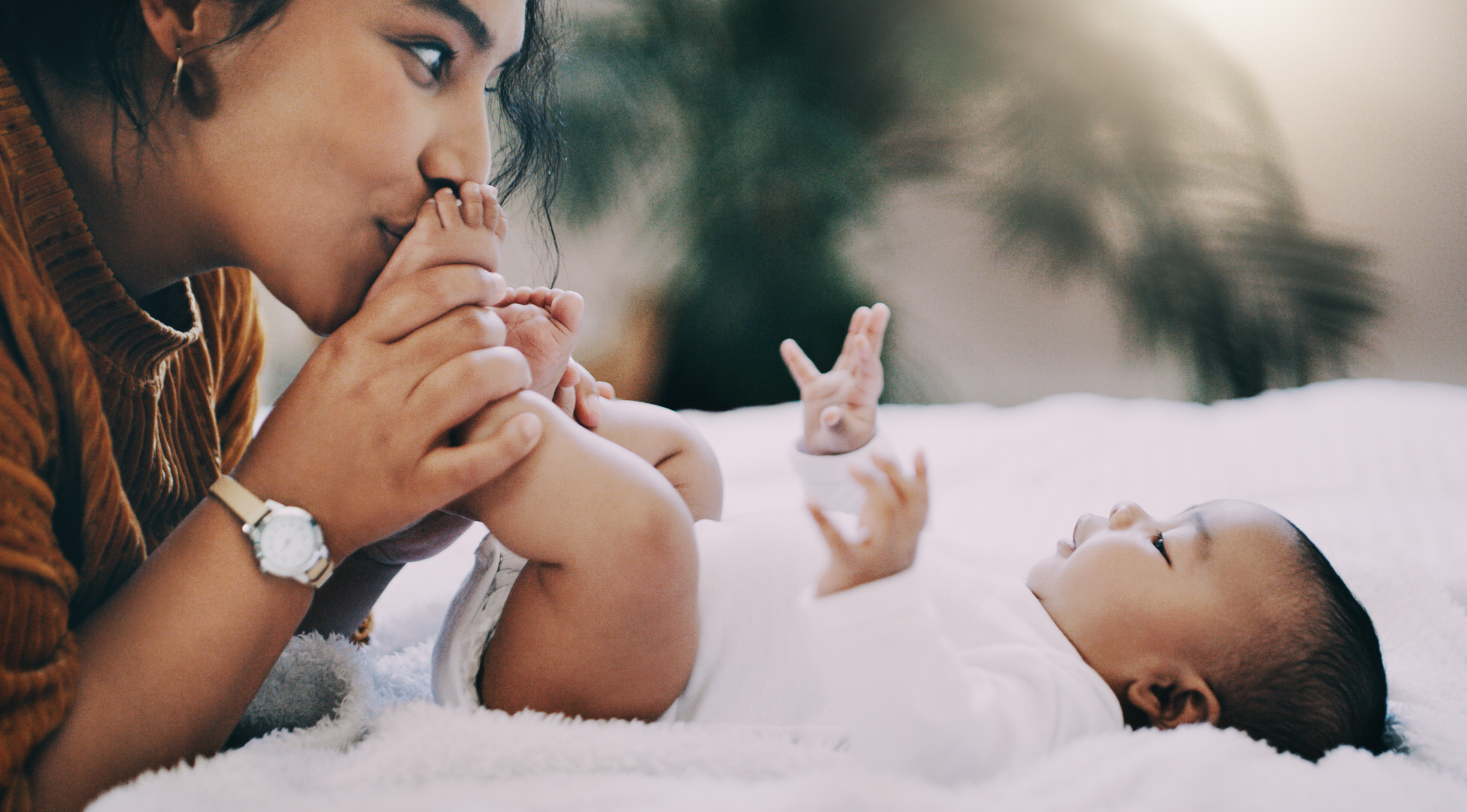 Shot of a young woman bonding with her adorable baby boy at home