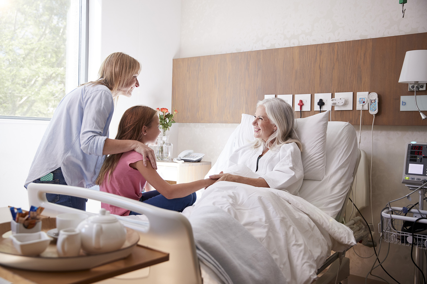 Granddaughter Talking With Grandmother On Family Hospital Visit