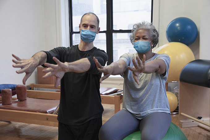 physical therapist and patient stretching