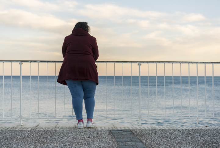 Woman staring out at ocean