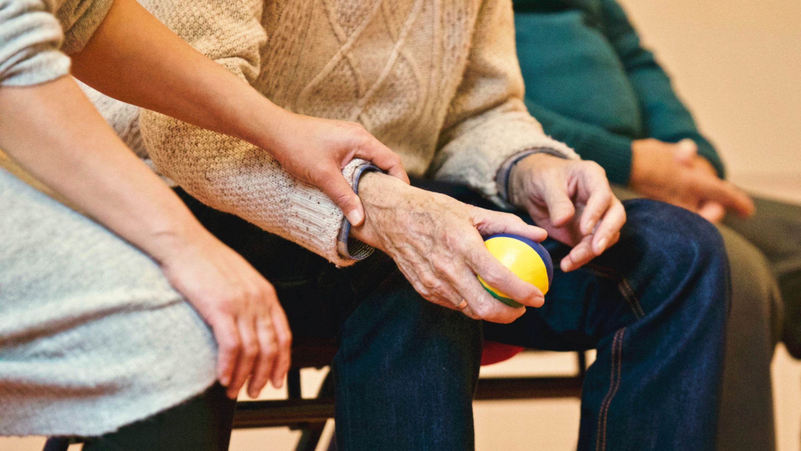 Elderly person holding stress ball