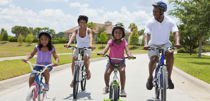 Black family riding bikes