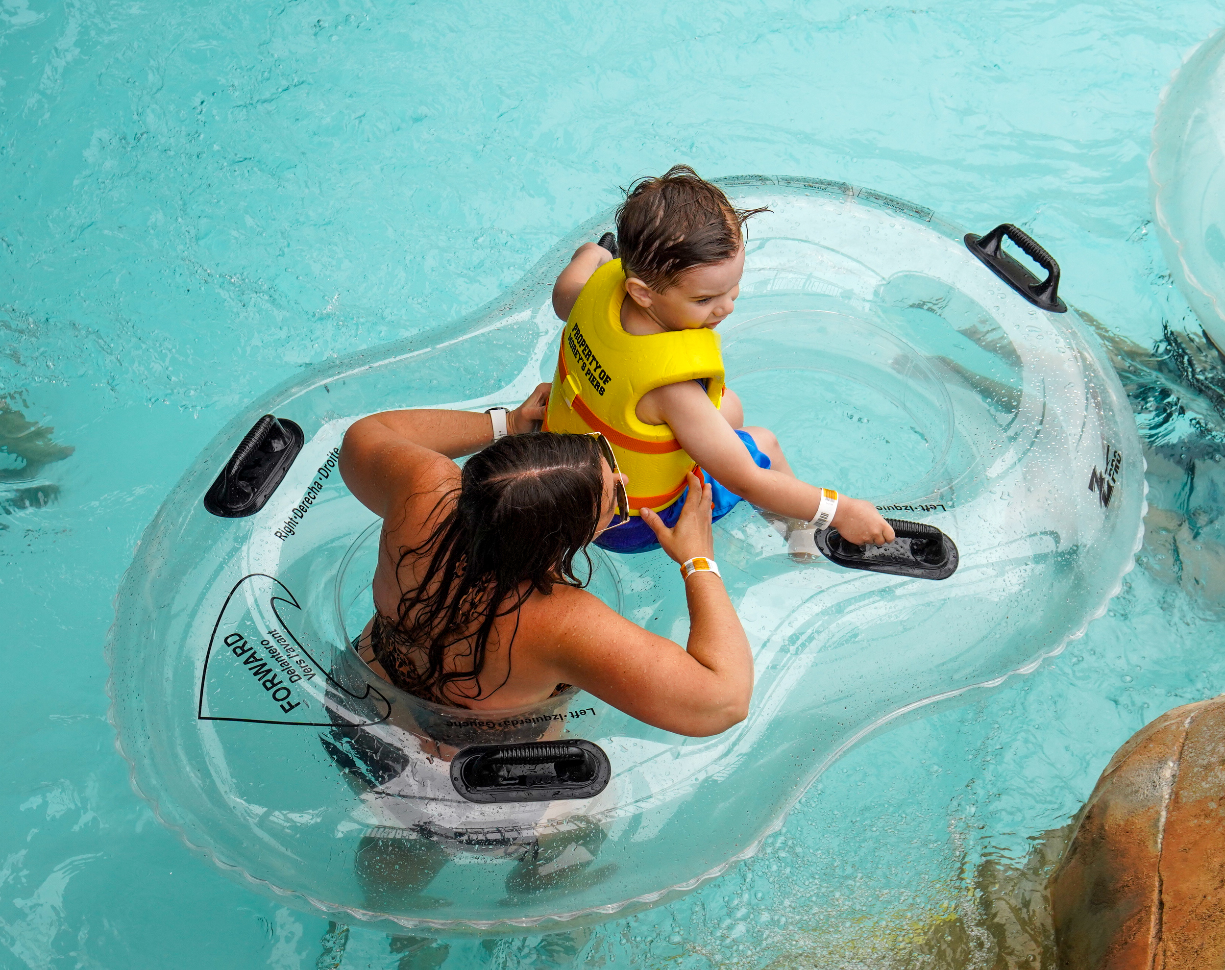 woman and child in lifevest in a double tube