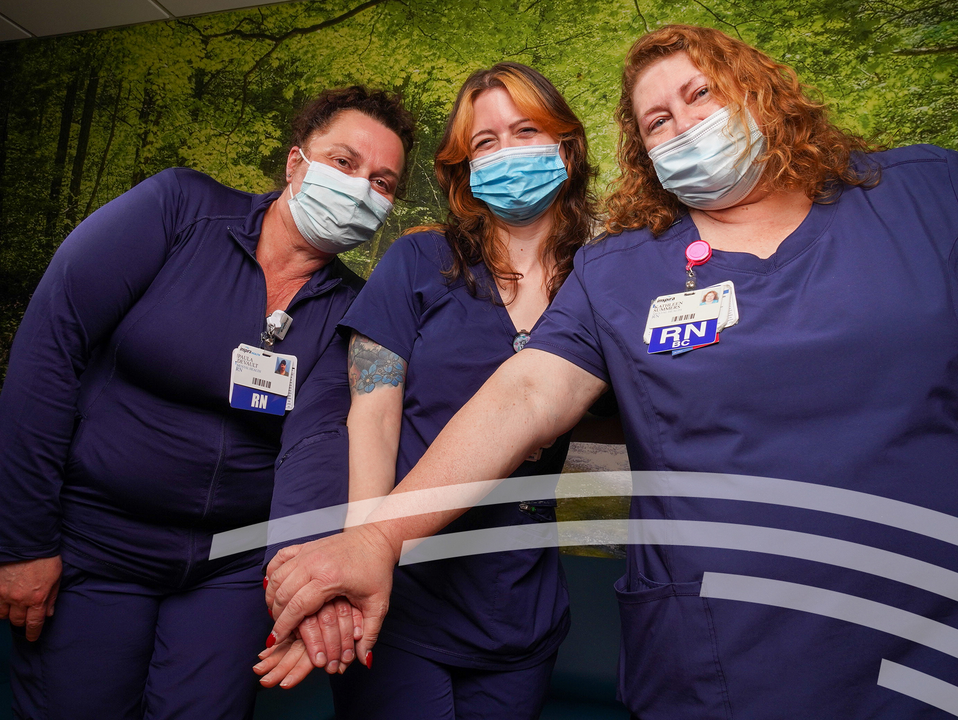 group of three female nurses holding hands