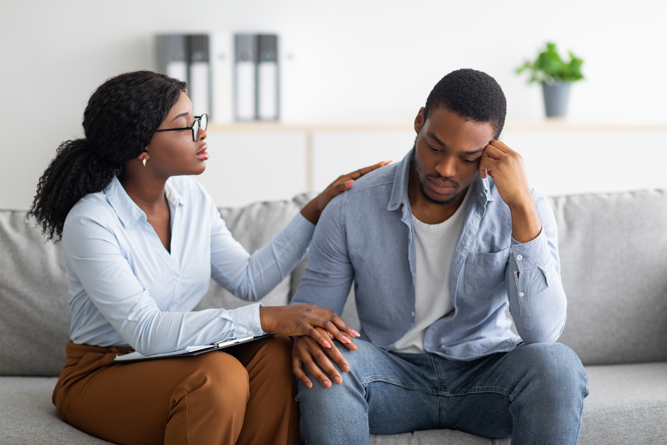 Young woman comforting man who is emotional