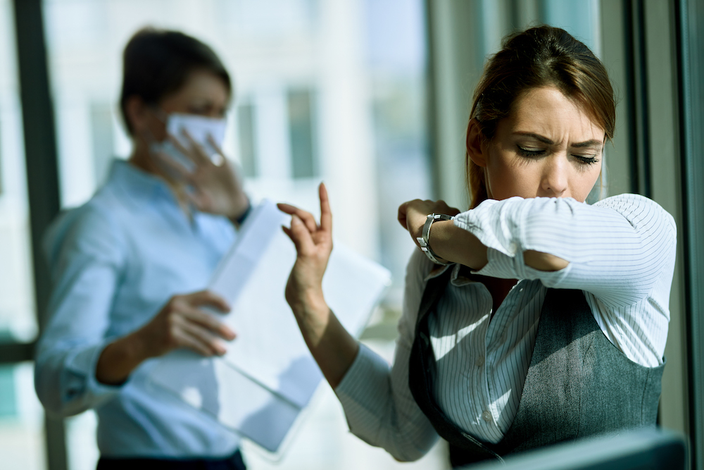 Woman with COVID Coughing into Arm