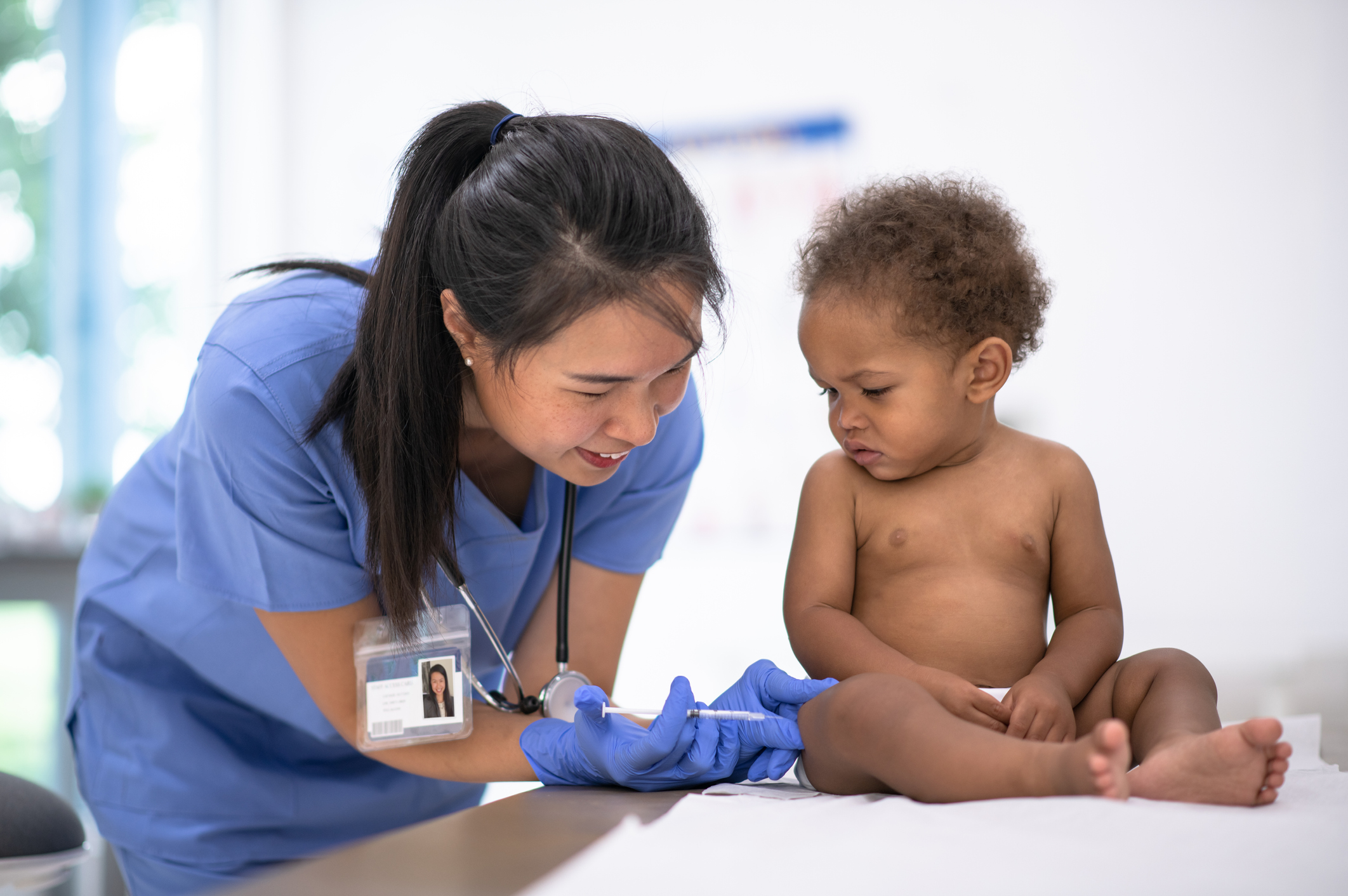 baby receiving immunizations from doctor