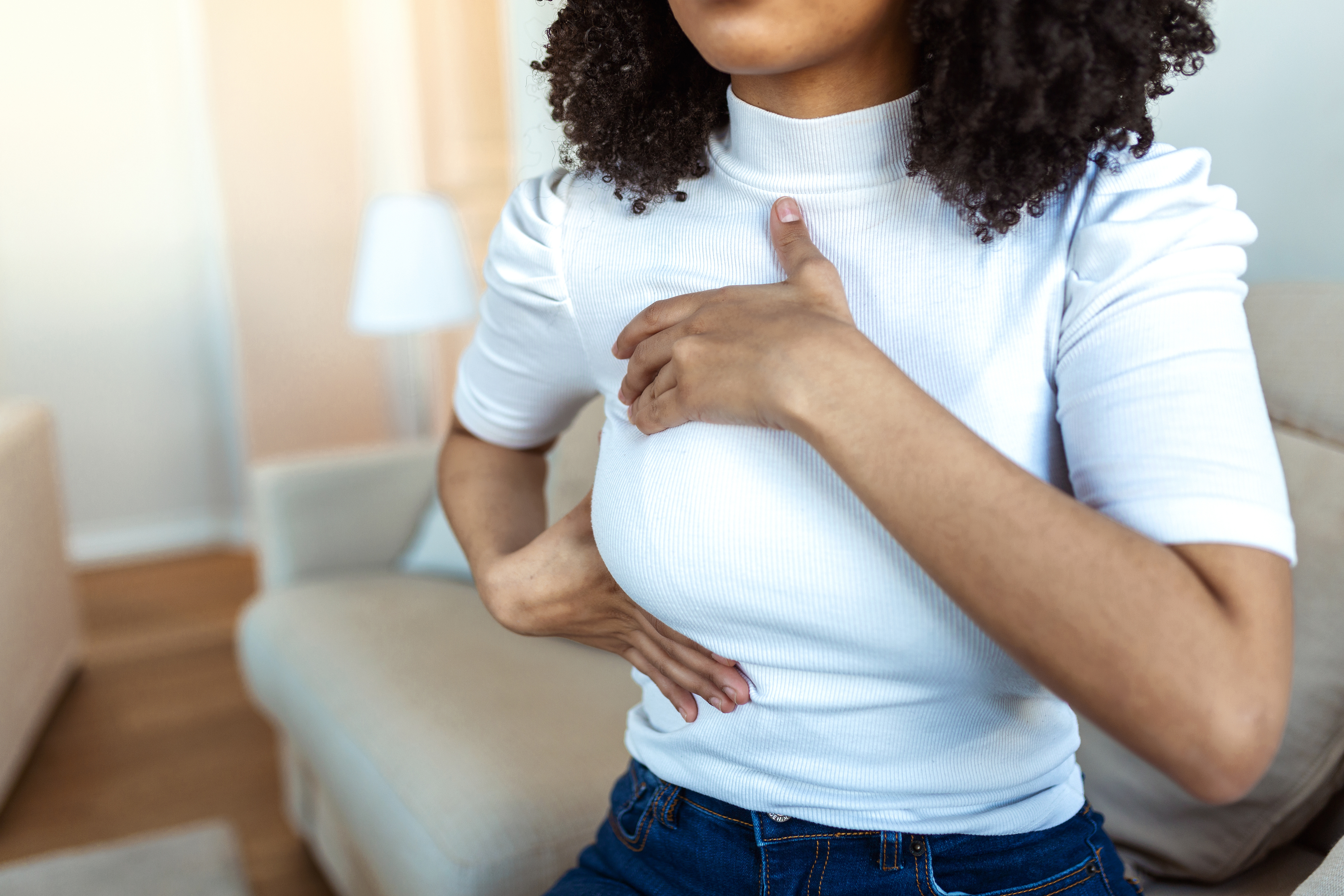 5 Facts Everyone Should Know About Breast Health 5 African American Woman hand checking lumps on her breast for signs of breast cancer. woman is suffering from pain in the breast. BSE or Breast Self-Exam. Guidelines to check for breast cancer.