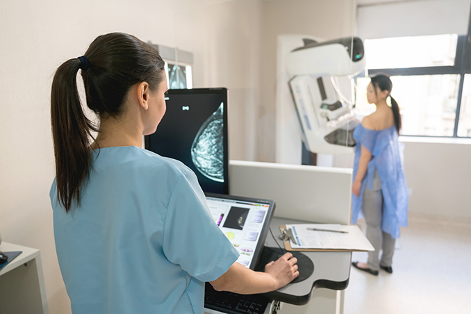 Young woman is having mammography examination at the hospital or private clinic with a professional female doctor.