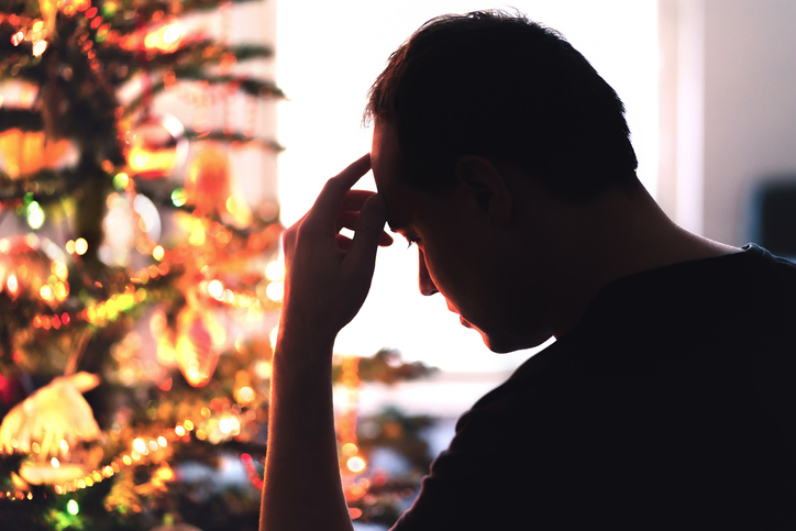 Unhappy, lonely or tired man with stress, grief or depression sad on Christmas.