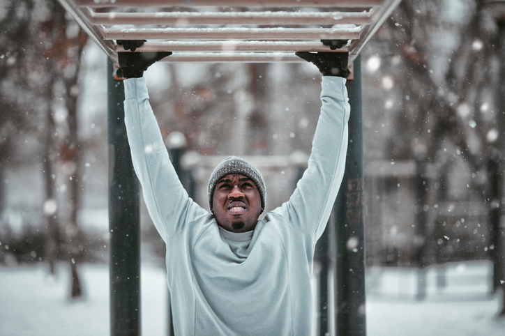 Photo of a sporty man exercising in the snow