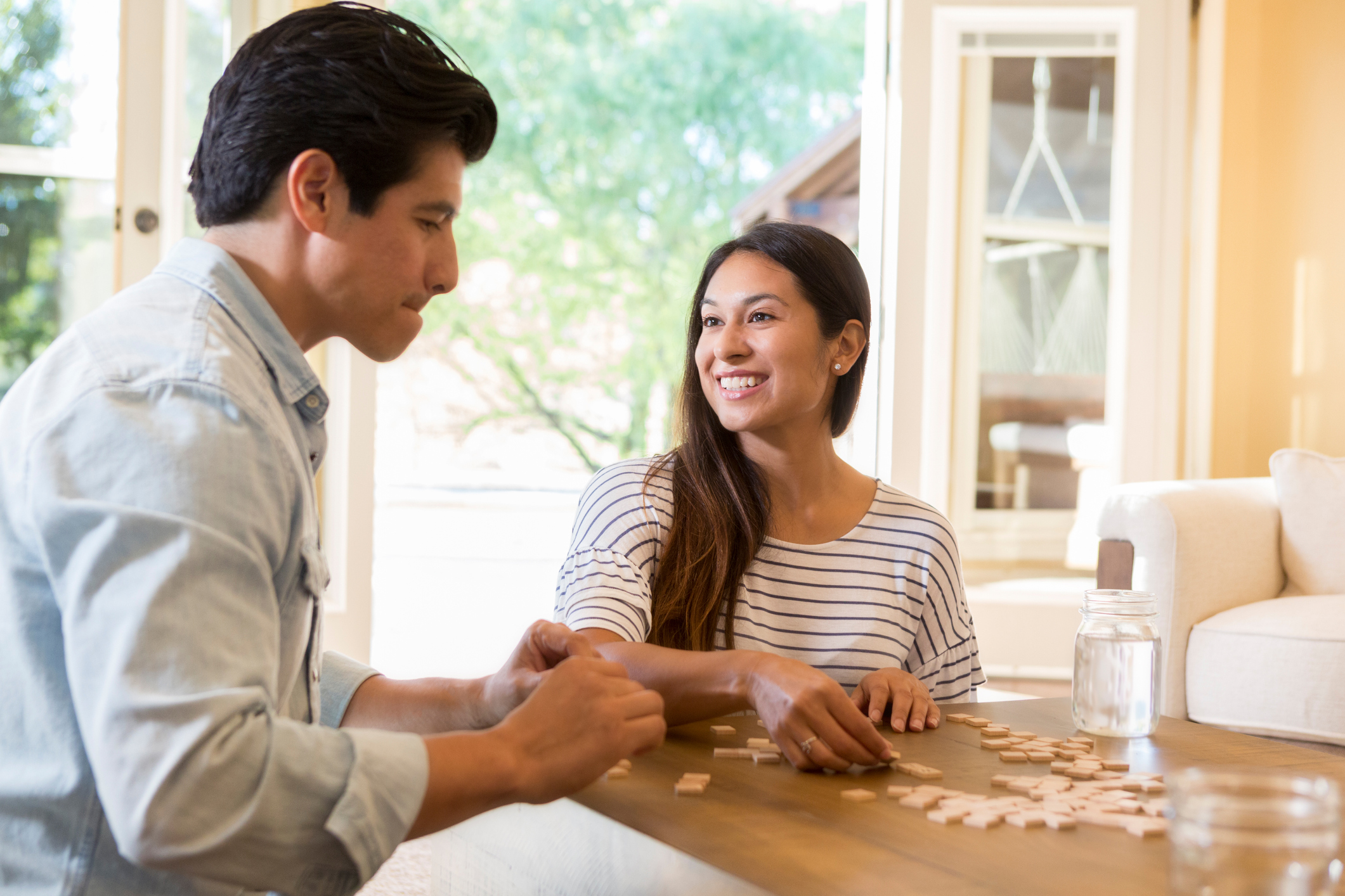 married couple play word game at home