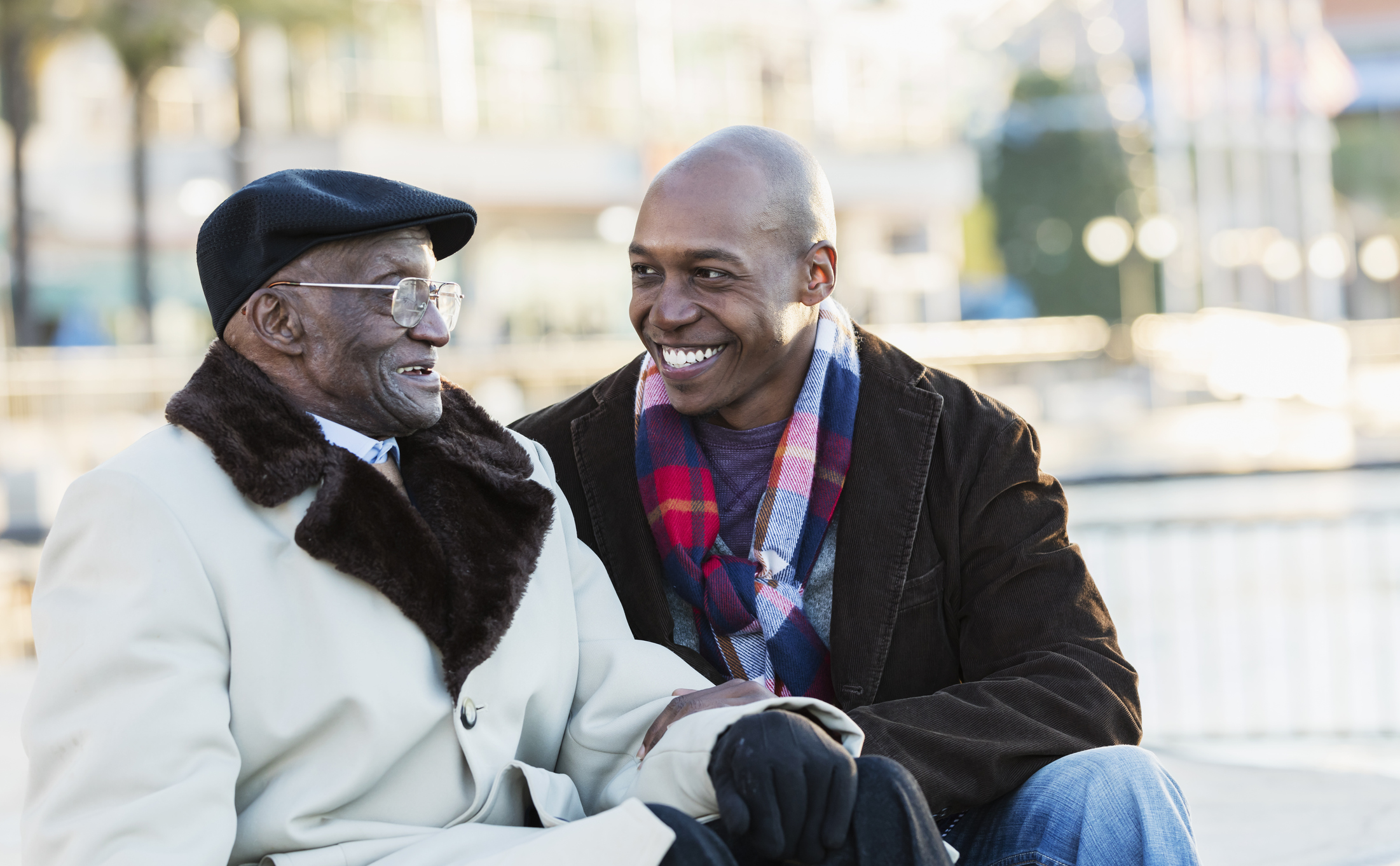 African-American man with grandfather In city 