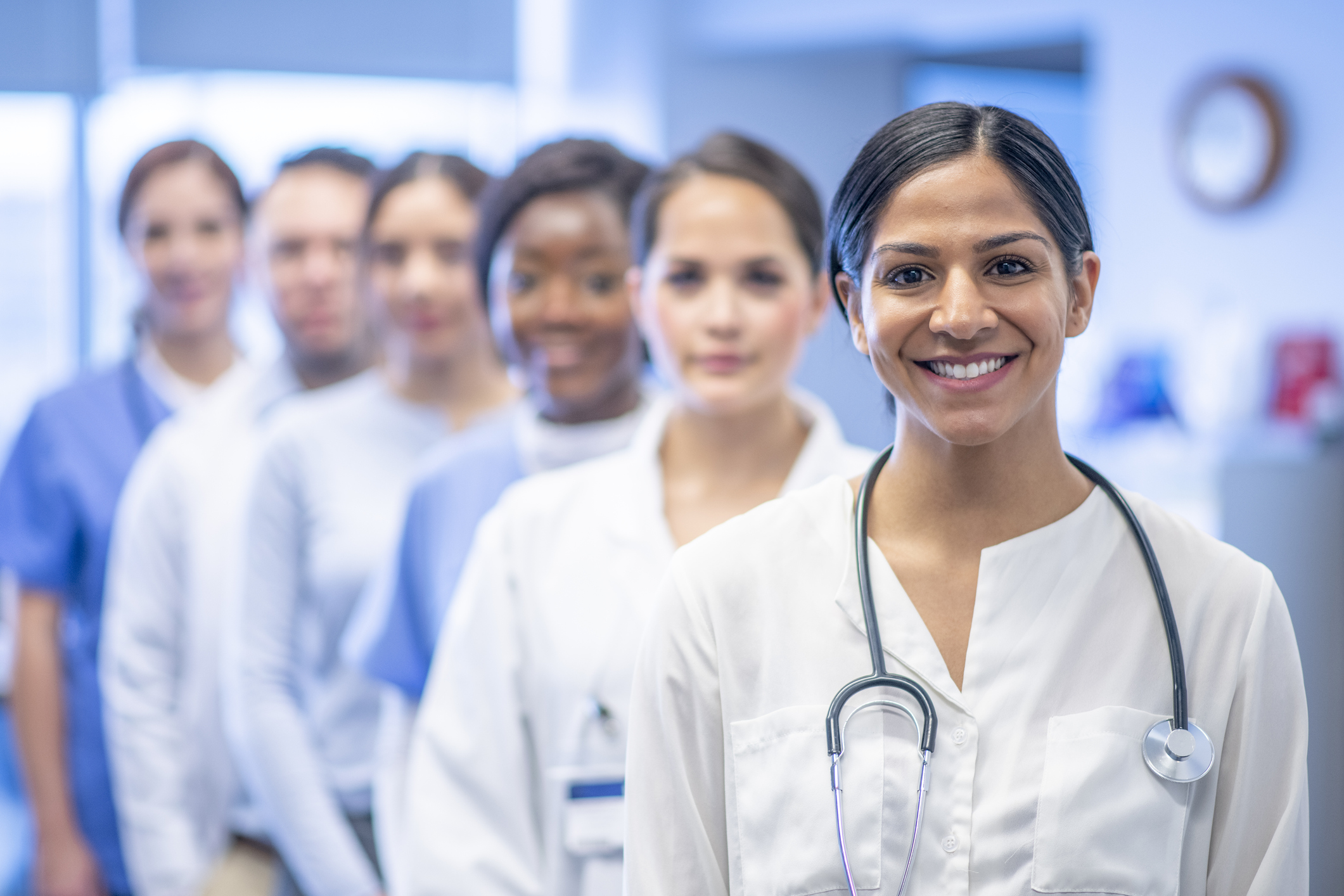 A beautiful group of multi ethnic medical students smiles together at the camera