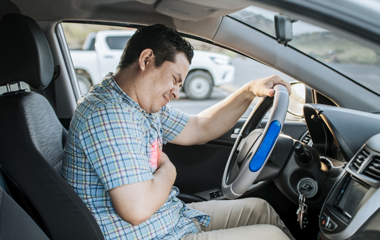 Person with heart attack while driving. Driver with chest pain.