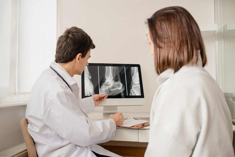 Orthopedic Surgeon Explaining X-Ray to Women