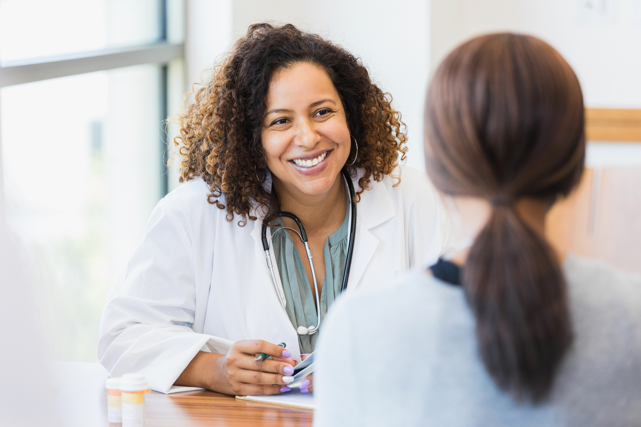 Hispanic physician speaking with a patient