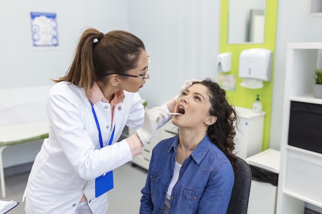 Doctor Looking inside Patient throat