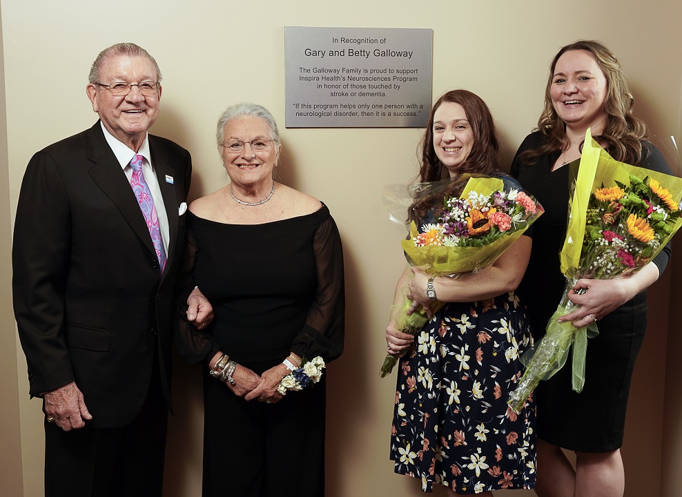 One Senior Couple with Two Ladies Holding Flowers