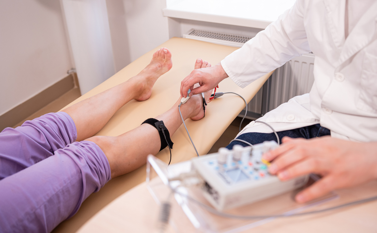 Doctor checking patients legs for any artery disease